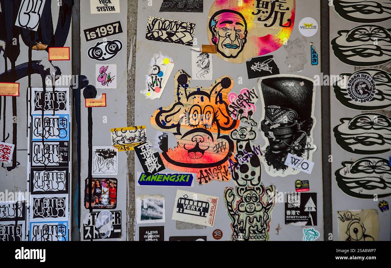 Nahaufnahme einer Wand mit einer farbenfrohen Vielfalt an Aufklebern und Graffiti im Westen Tokios Stockfoto