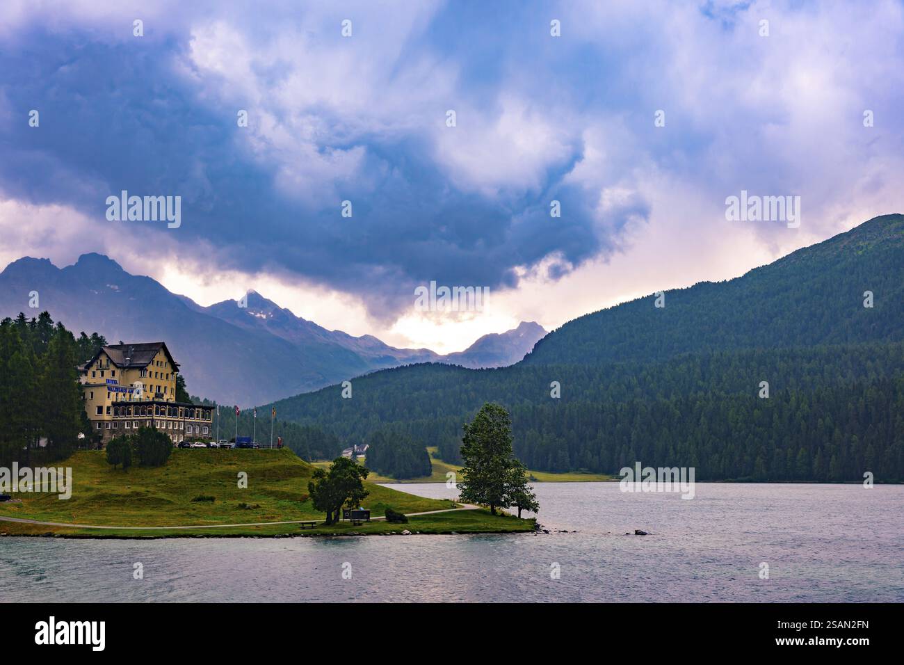 Panoramablick über das Hotel Waldhaus am See und den Sankt Moritzsee mit Bergblick und Tal mit Sturmwolken über den Schweizer Alpen im bewölkten Sommer Stockfoto