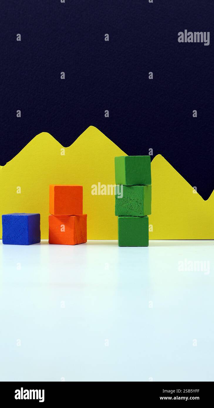 Balkendiagramm aus farbigen Holzwürfeln mit blauem Kopierraum im Hintergrund. Stockfoto