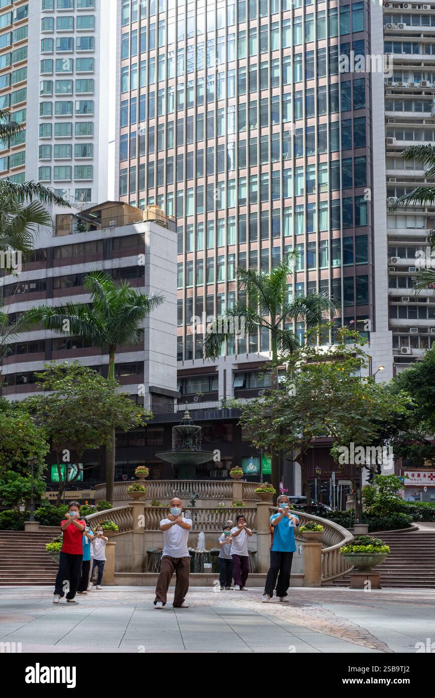 Die morgendliche Tai Chi-Praxis in der Nähe des Cosco Tower in Sheung Wan vereint Körper und Geist inmitten der geschäftigen Stadt Stockfoto Die morgendliche Tai Chi-Praxis in der Nähe des Cosco Tower in Sheung Wan vereint Körper und Geist inmitten der geschäftigen Stadt Stockfoto