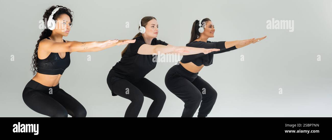 Drei starke Frauen hocken in einem modernen Fitnessstudio zusammen und zeigen Einheit und Fitness. Stockfoto