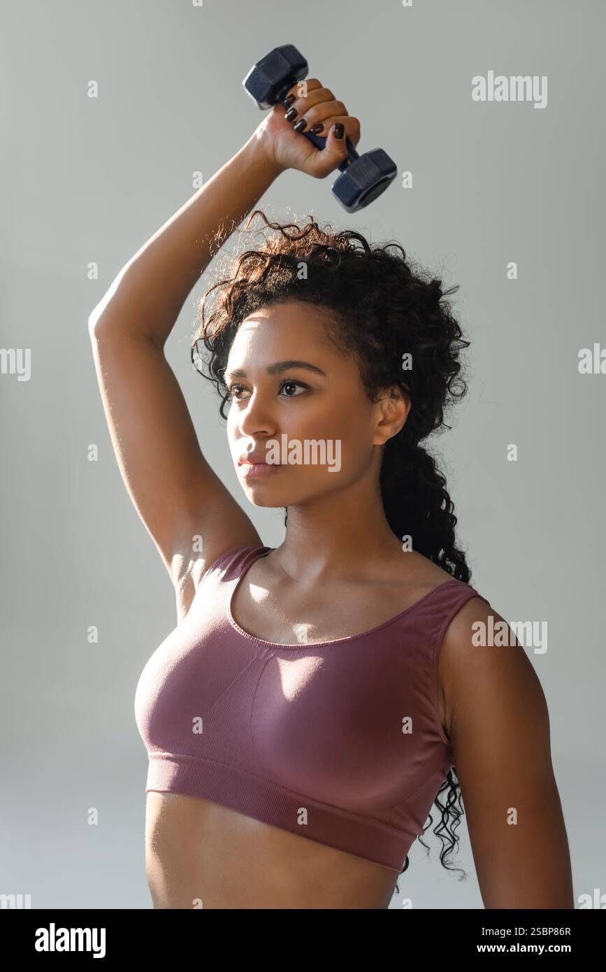 Leistungsfähige Sportlerin engagiert sich im Krafttraining und demonstriert damit Fitness und Entschlossenheit. Stockfoto