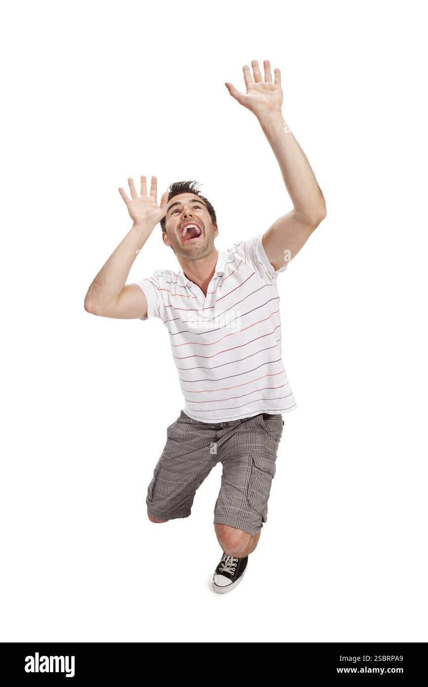 Porträt eines jungen überraschten Mannes, der Gesten gibt. Isoliert auf weiß Stockfoto