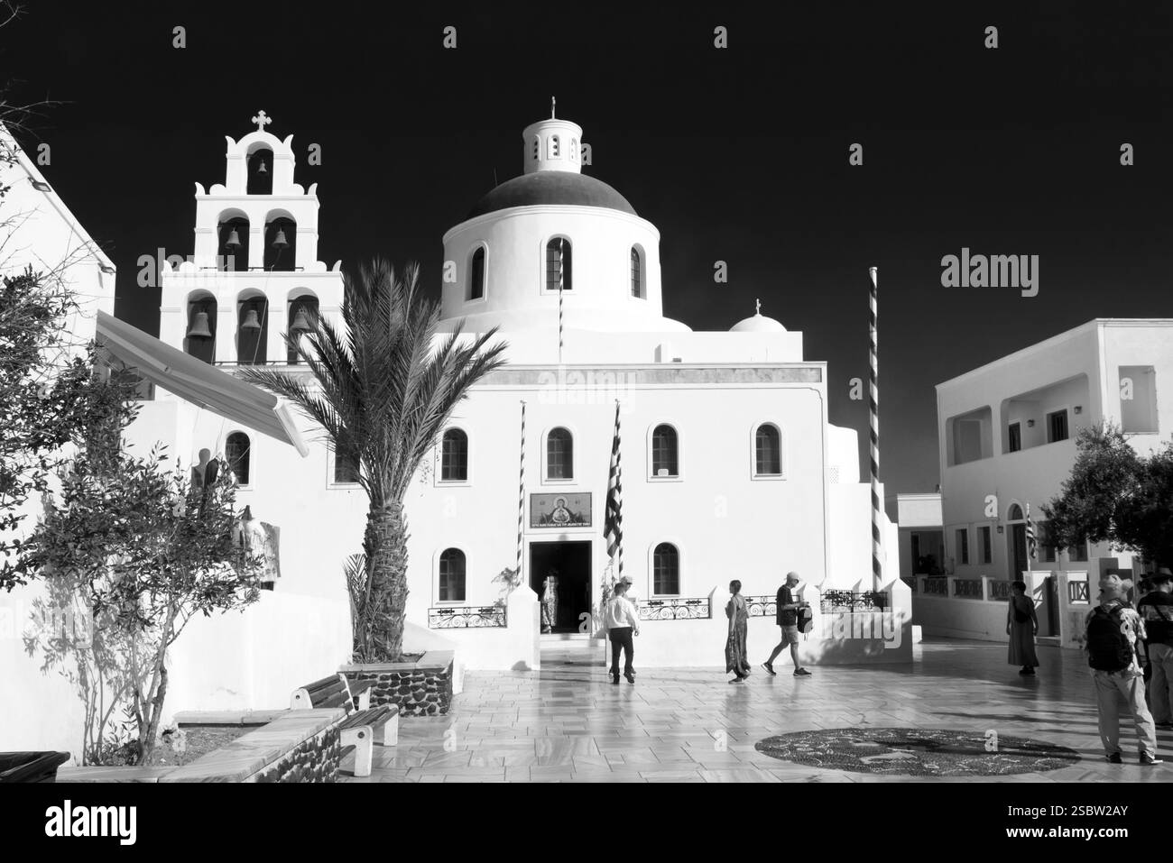 Oia, ein beliebtes Touristenziel auf Santorin, verfügt über berühmte weiße Häuser und Kirchen mit blauen Kuppeln, die sich an den Klippen mit Blick auf die Unterwasserkaldera schmiegen Stockfoto