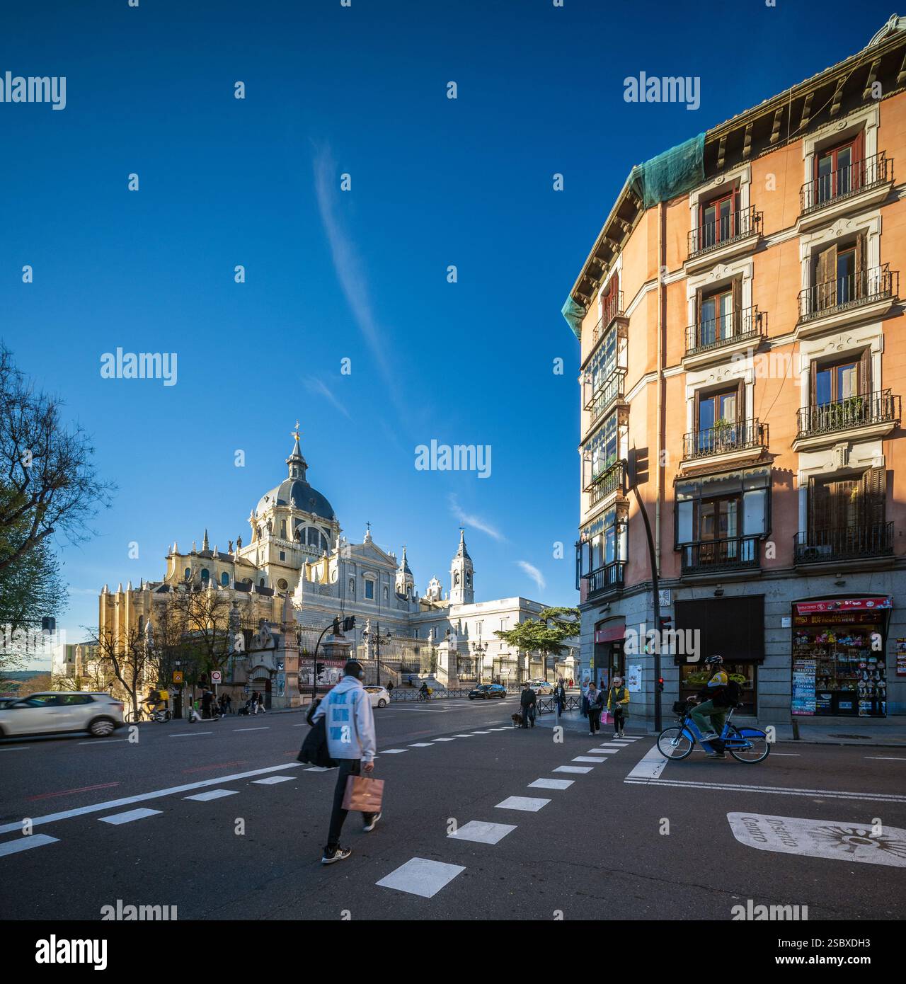 Kathedrale von Almudena und umliegende Architektur in Madrid, Spanien, mit Menschen und Verkehr. Stockfoto