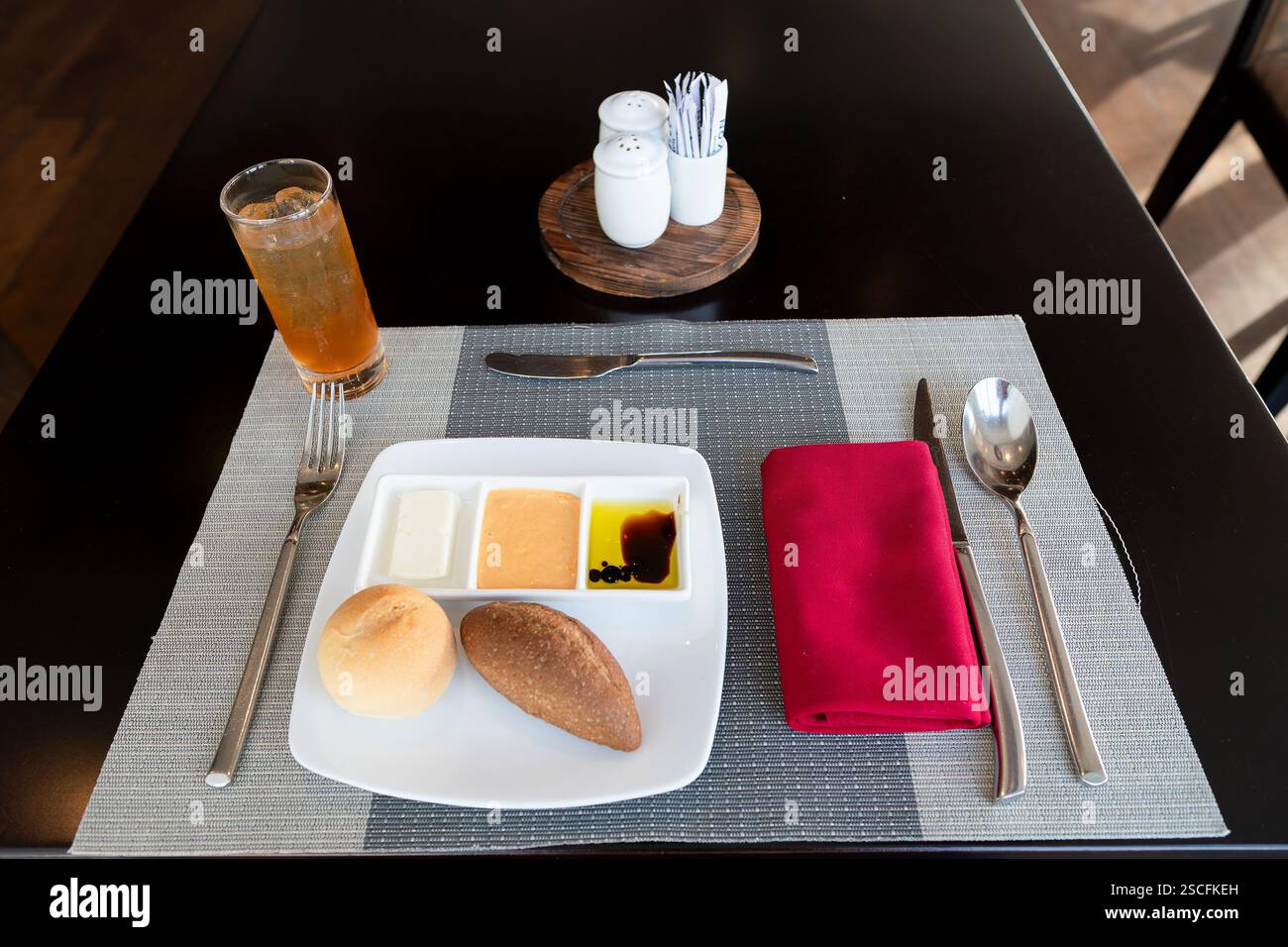 Ho Chi Minh, Vietnam - 23. August 2024: Hier werden frisch gebackene Brötchen serviert, serviert mit Butter, einem cremigen Dip und einem Olivenöl und Balsamico-Essig Stockfoto