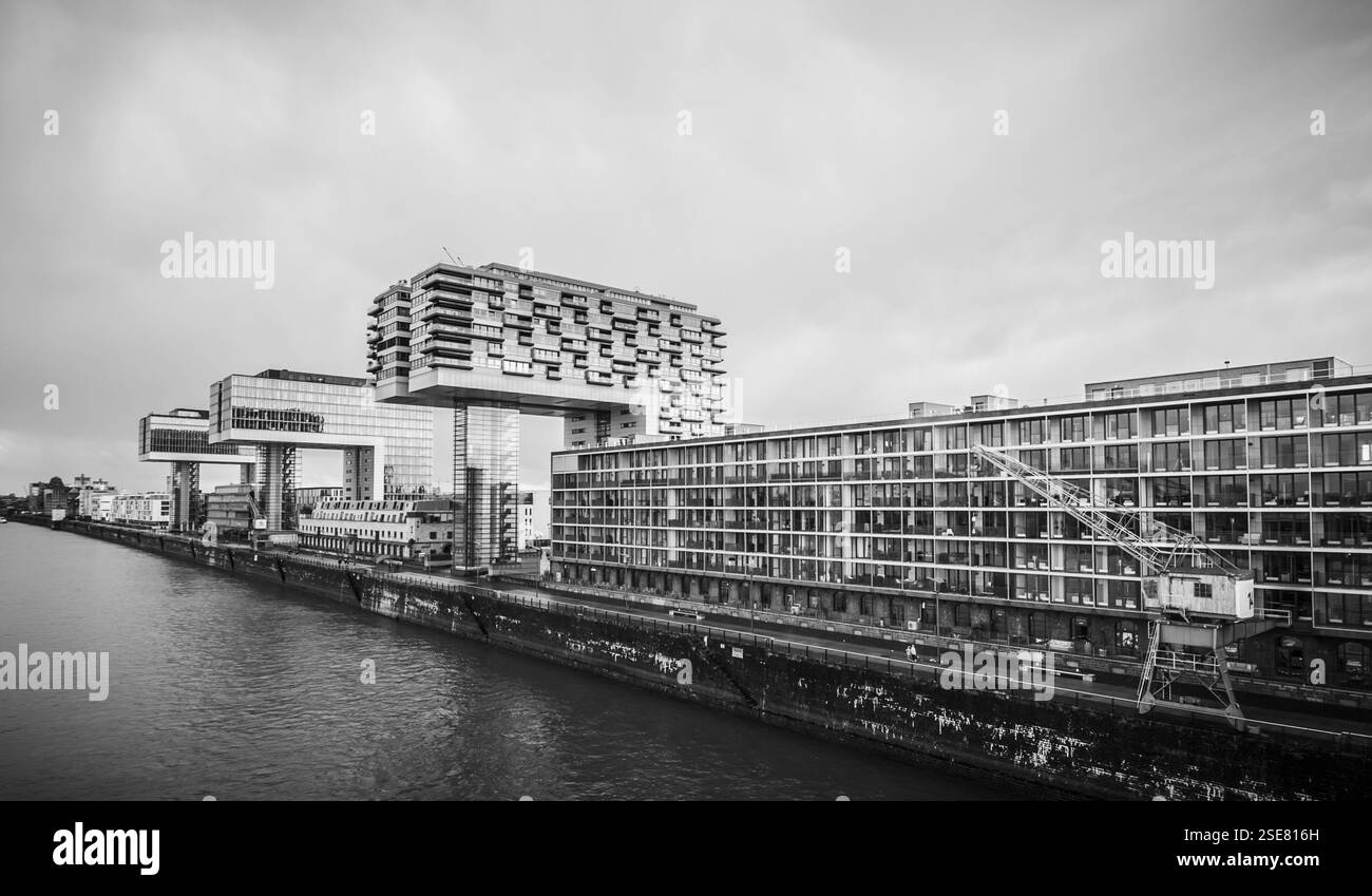 Ein beeindruckender Blick auf moderne Gebäude am Ufer mit einzigartigen geometrischen Formen und Strukturen. Die Umgebung spiegelt eine Mischung aus urbanem Ambiente wider Stockfoto