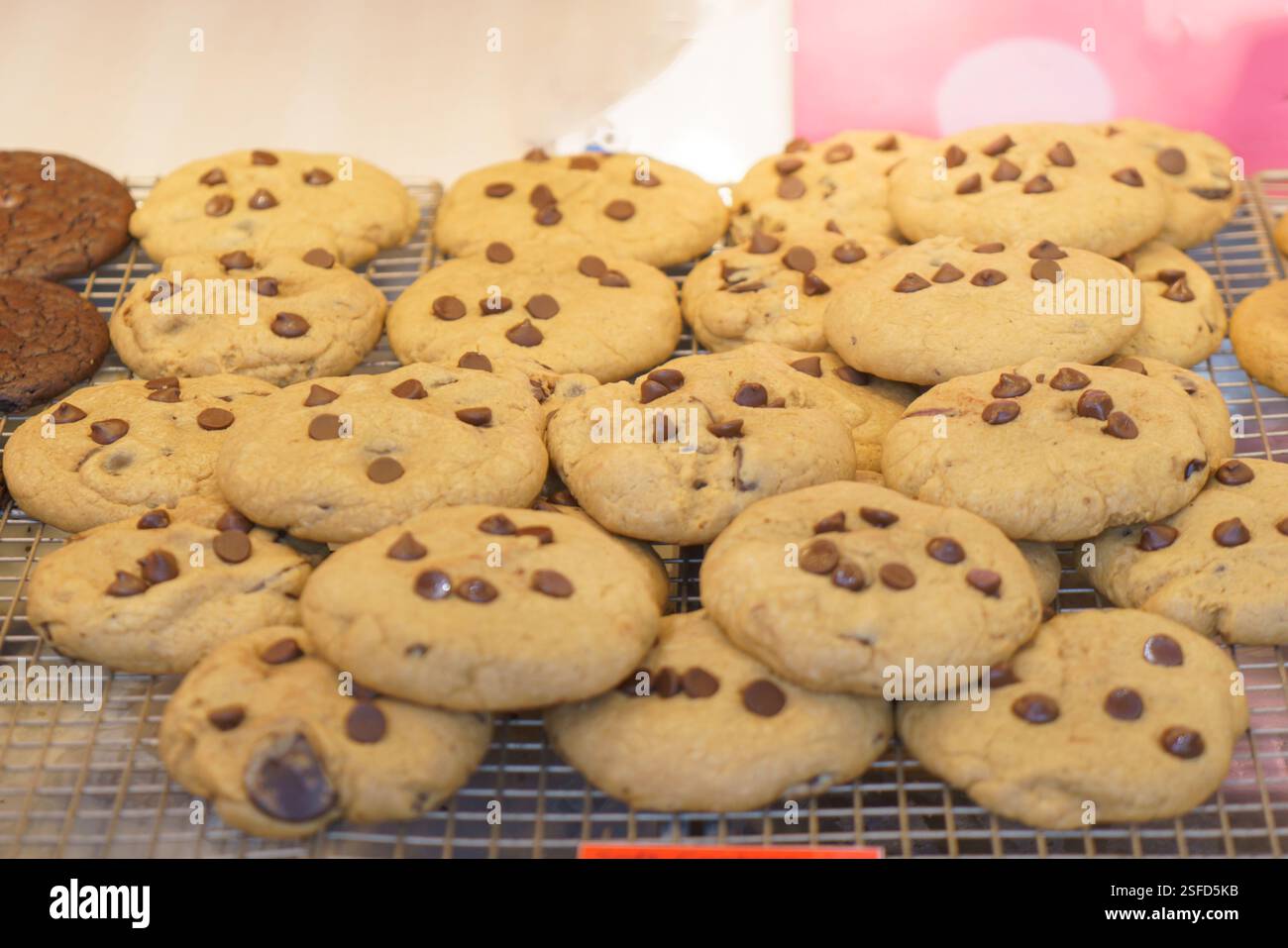 Nahaufnahme von frisch gebackenen Schokoladen-Chip-Cookies mit einer weichen, zähen Textur. Diese süßen Leckereien, die in einer Bäckerei ausgestellt werden, locken die Dessertliebe an Stockfoto