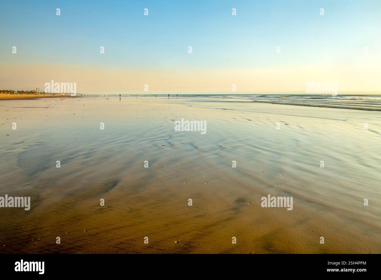 Ebbe am Huntington Beach mit einem rauchigen Himmel in der Abenddämmerung zeigt die friedliche, ruhige Lage eines nicht überfüllten Strandes. Stockfoto