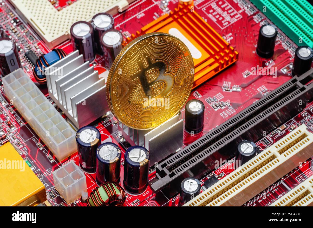 Goldener Bitcoin von oben auf der Computerplatine. Bitcoin-Mining-Farm zum Mining von elektronischem Geld Stockfoto