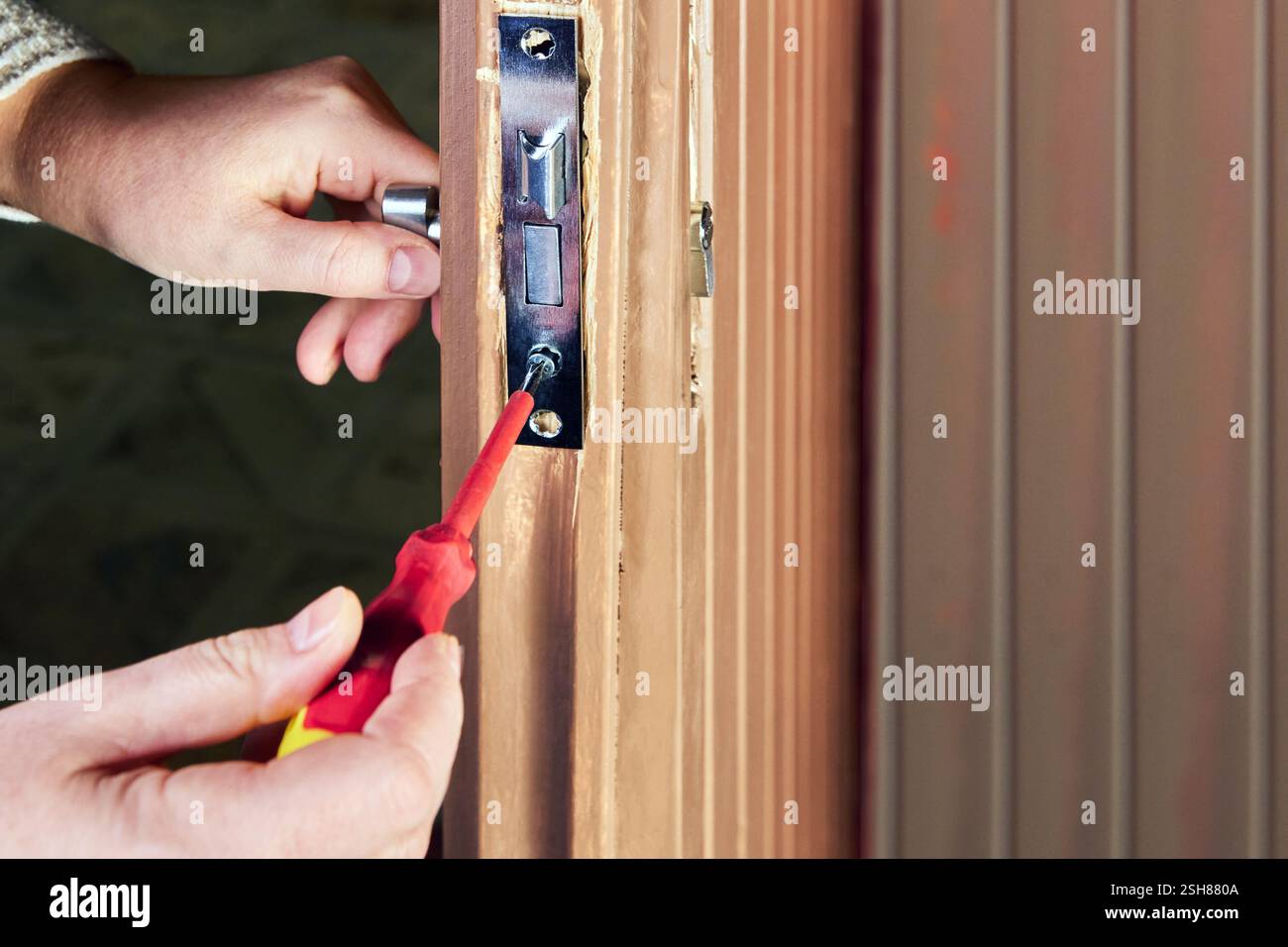 Arbeiter, der die Einstecksperre während der Installation anpasst. Stockfoto