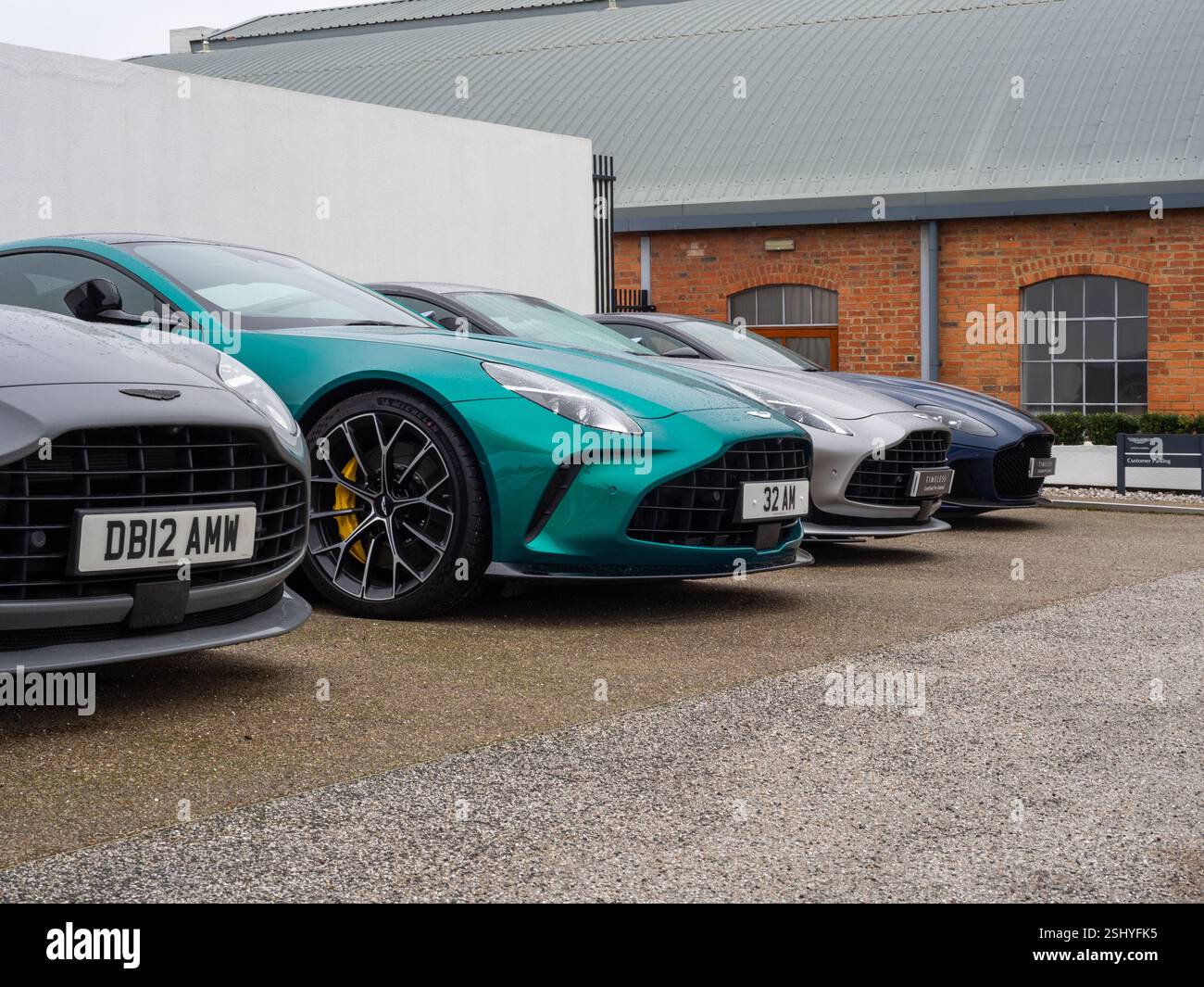 Autos standen auf dem Vorplatz des Aston Martin Showrooms, Newport Pagnell, Buckinghamshire, Großbritannien Stockfoto