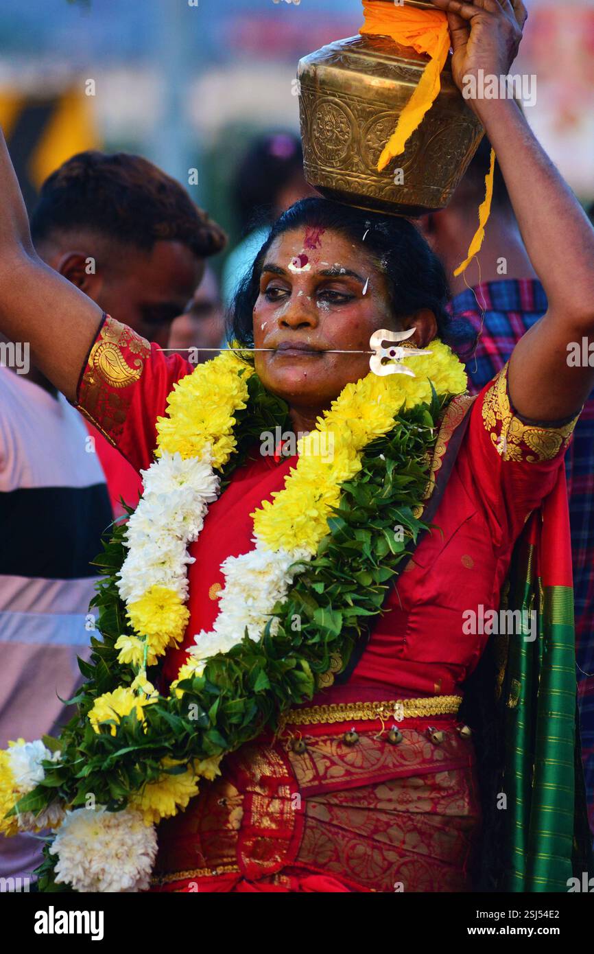 MALAYSIA KUALA LUMPUR 25.11.02.25. Thaipusam ist ein tamilisches Hindu-Festival, das am ersten Vollmondtag des tamilischen Monats Thai gefeiert wird und mit dem Pusam-Stern zusammenfällt. Das Festival wird zum Gedenken an den Sieg des hinduistischen Gottes Murugan über den Dämon Surapadman gefeiert. Während der Schlacht soll Murugan einen Egel getragen haben, einen göttlichen Speer, der von seiner Mutter Parvati gewährt wurde. Das Festival beinhaltet rituelle Praktiken von Kavadi Aattam, ein zeremonieller Akt des Opfers, der eine physische Last trägt, um eine spirituelle Schuld auszugleichen. Gläubige tragen oft einen Topf Kuhmilch als Opfergabe und tun es auch Stockfoto MALAYSIA KUALA LUMPUR 25.11.02.25. Thaipusam ist ein tamilisches Hindu-Festival, das am ersten Vollmondtag des tamilischen Monats Thai gefeiert wird und mit dem Pusam-Stern zusammenfällt. Das Festival wird zum Gedenken an den Sieg des hinduistischen Gottes Murugan über den Dämon Surapadman gefeiert. Während der Schlacht soll Murugan einen Egel getragen haben, einen göttlichen Speer, der von seiner Mutter Parvati gewährt wurde. Das Festival beinhaltet rituelle Praktiken von Kavadi Aattam, ein zeremonieller Akt des Opfers, der eine physische Last trägt, um eine spirituelle Schuld auszugleichen. Gläubige tragen oft einen Topf Kuhmilch als Opfergabe und tun es auch Stockfoto