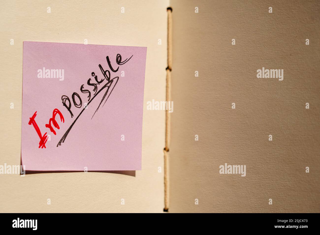 „Impossible“ wurde auf einer Haftnotiz zu „I’m possible“ gewechselt, um Selbstglauben und Ausdauer hervorzuheben. Stockfoto