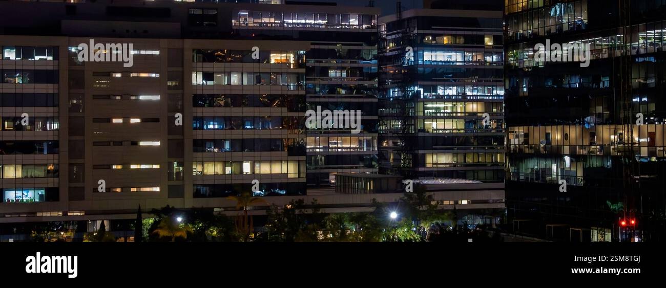 Bürofenster in Hochhäusern bei Nacht Stockfoto