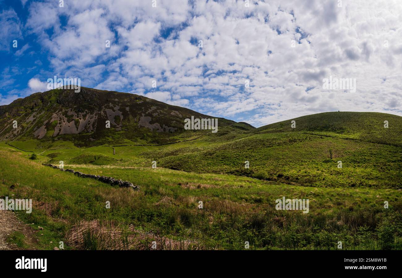 Ruhige Hügel und grüne Landschaften in der Nähe des Start of Minffordd Path zum Penygader (Cadair Idris) unter einem Himmel der Wolken Stockfoto