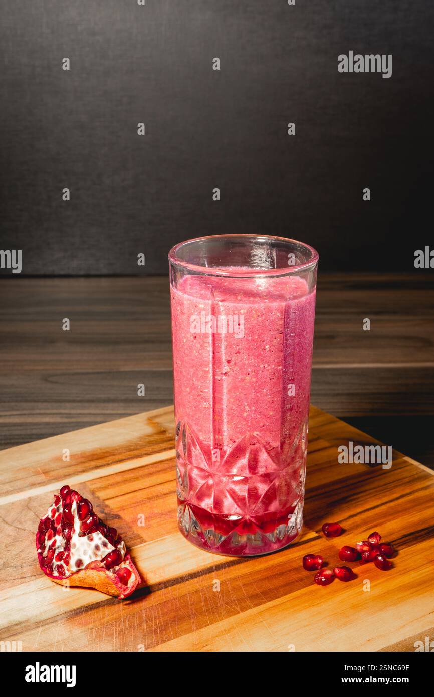 Ein Stück Pomegrenade mit einem Glas Pomegrenade-Saft. Stockfoto