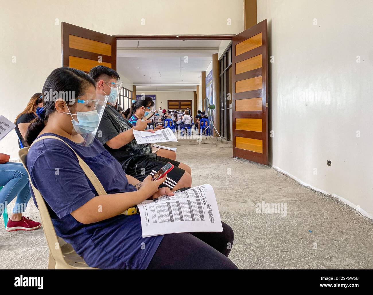 COVID 19 Mega-Impfstelle in einem Kongresszentrum für philippinische nationale Impftage, Provinz Philippinen, Gesichtsmasken und Schilde obligatorisch - Smartphone-aufgenommenes Stockfoto