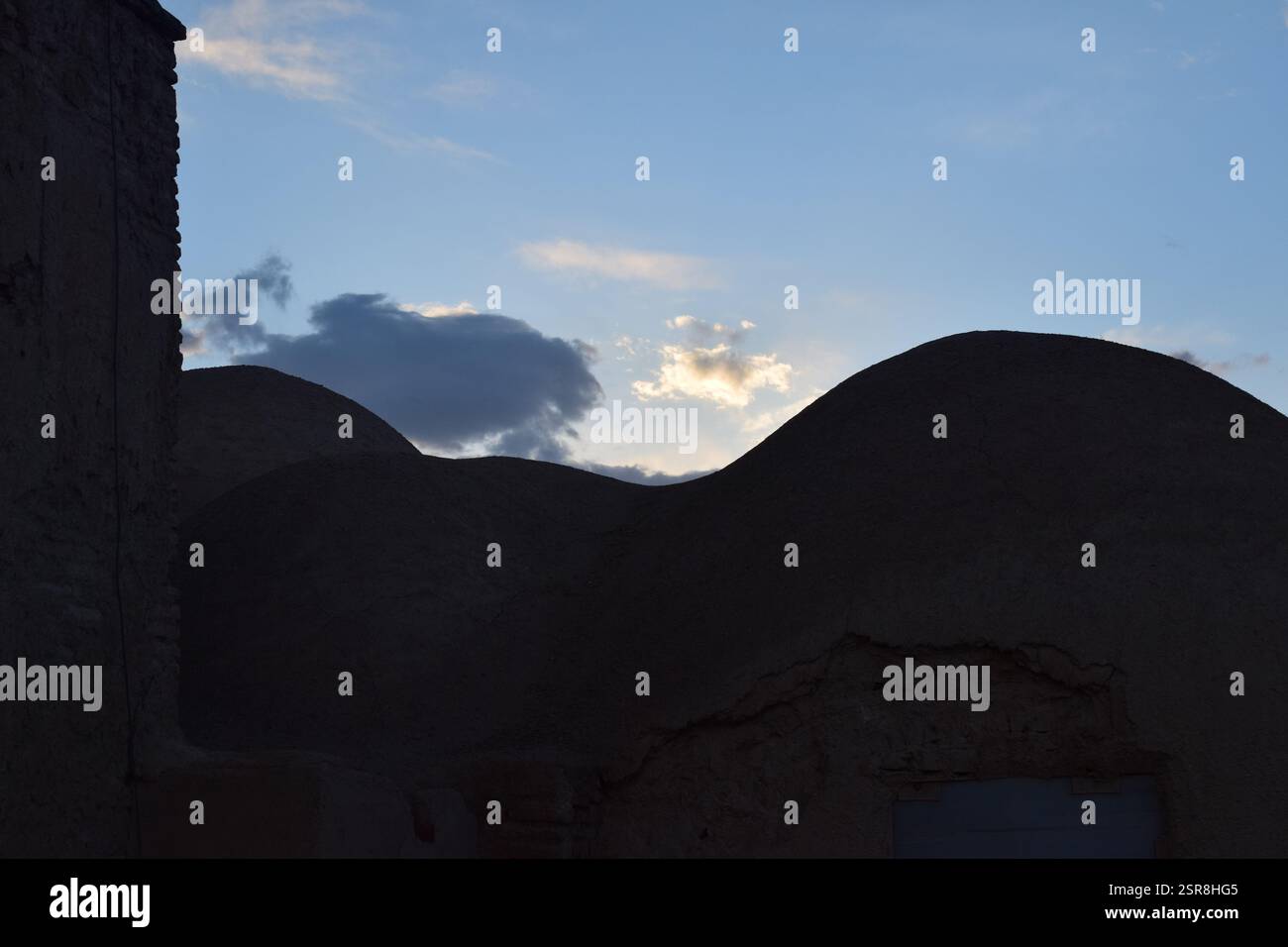 Traditionelles Kuppelhaus aus Lehmziegeln im Iran bei Sonnenuntergang, das historische persische Wüstenarchitektur mit Erdtexturen zeigt Stockfoto Traditionelles Kuppelhaus aus Lehmziegeln im Iran bei Sonnenuntergang, das historische persische Wüstenarchitektur mit Erdtexturen zeigt Stockfoto