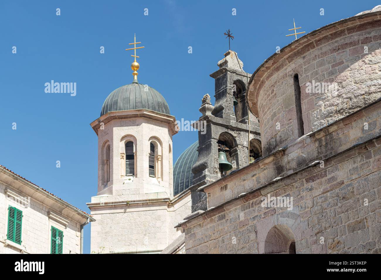 Eine traditionelle Kirche mit Mauerwerk und Glockentürmen vor einem leuchtend klaren blauen Himmel. Die architektonischen Details und das harmonische Design spiegeln seine wider Stockfoto