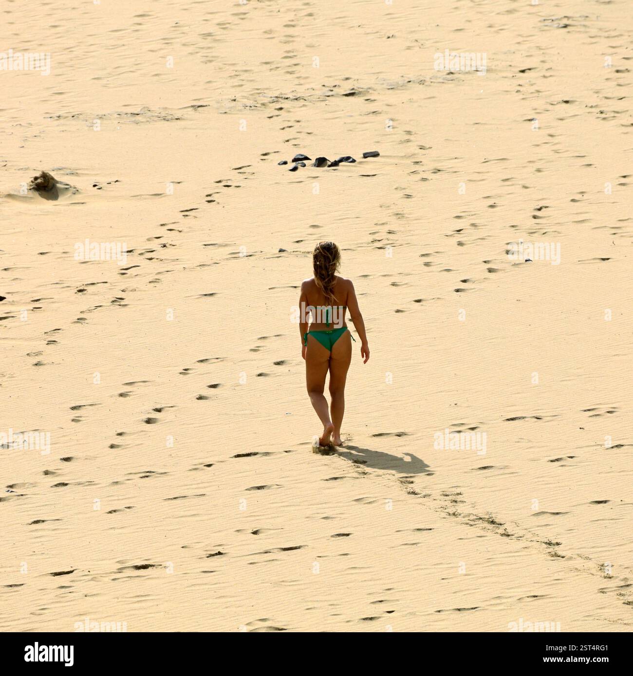 Einsame blonde Frau im grünen Bikini, die Piedra Playa Beach, Fuerteventura, Kanarische Inseln, Spanien, EU erkundet. Aufgenommen Im Winter 2024 Stockfoto