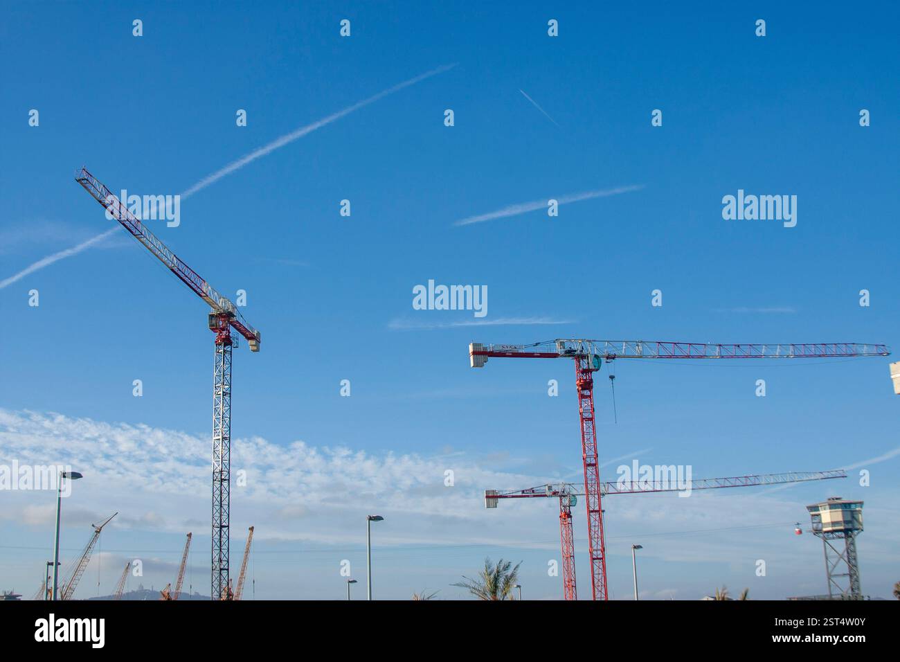 Blauer Himmel mit Kranichen. Minimalistische Komposition, industrielle Elemente und ein Gefühl für Größe, Baustelle, Industrielandschaft und Fortschritt. Stockfoto
