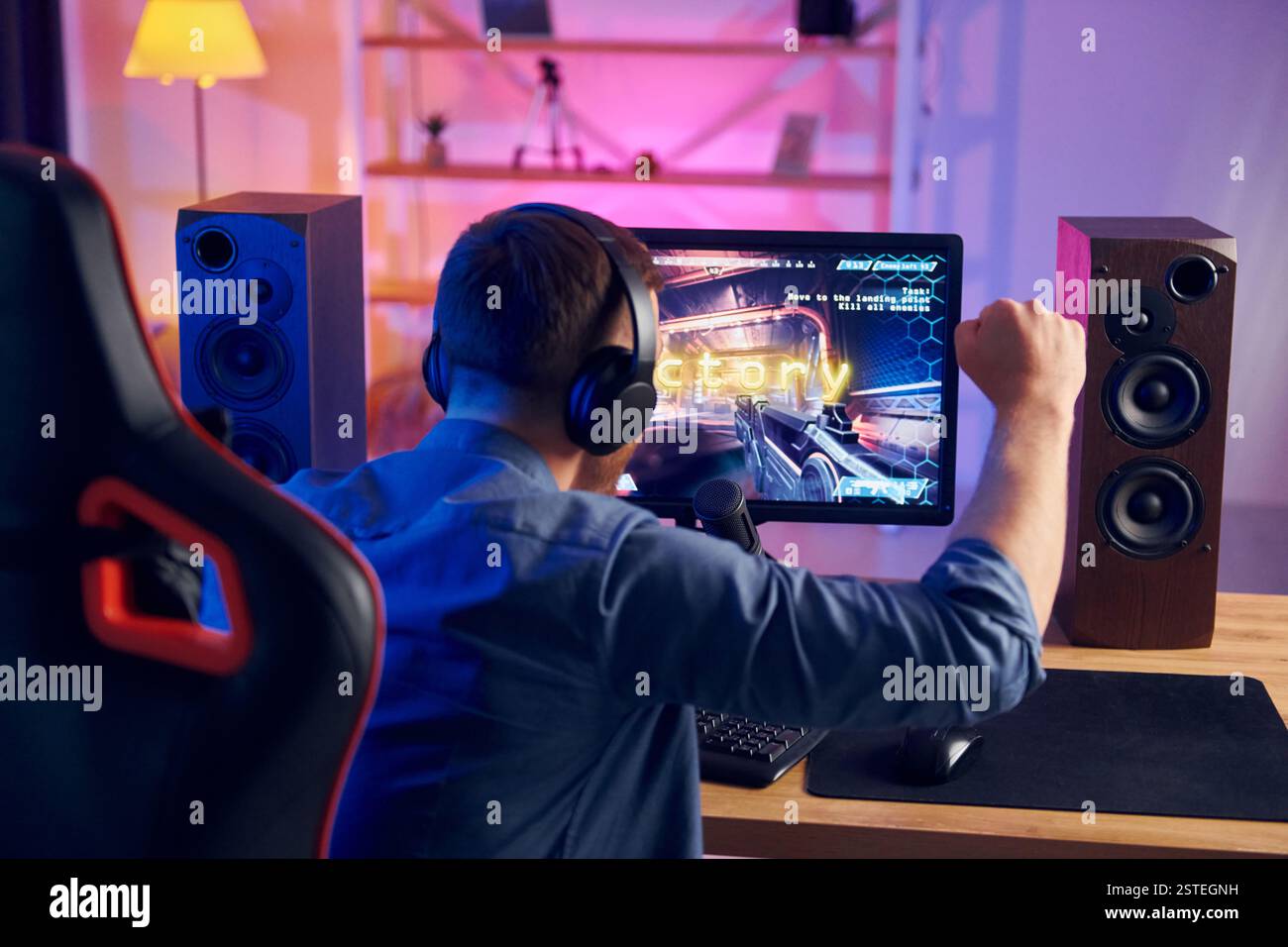 Schöner Spielstuhl. Online-Streamer spielt FPS-Shooter zu Hause. Stockfoto