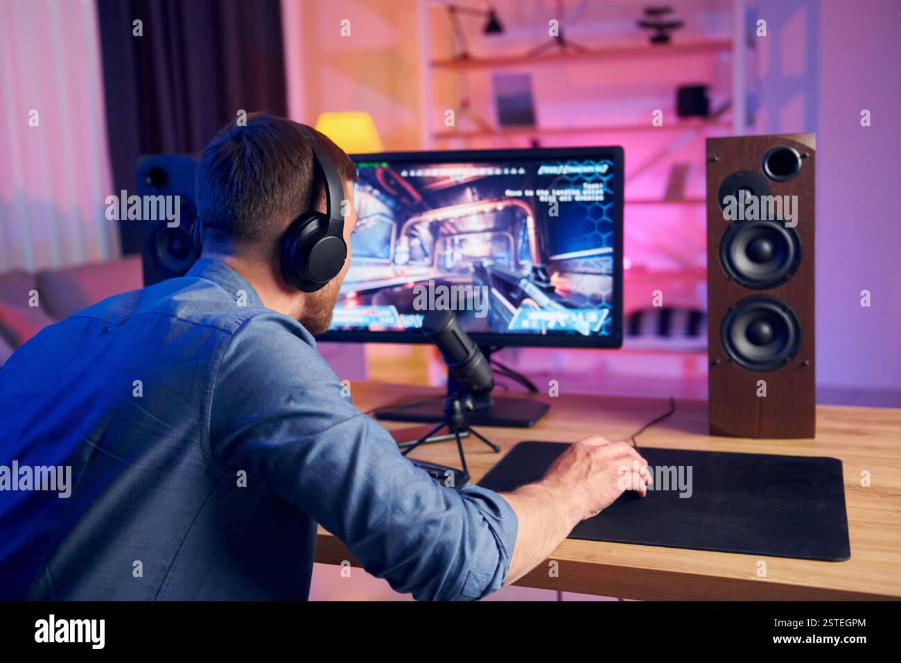 Schöner Spielstuhl. Online-Streamer spielt FPS-Shooter zu Hause. Stockfoto