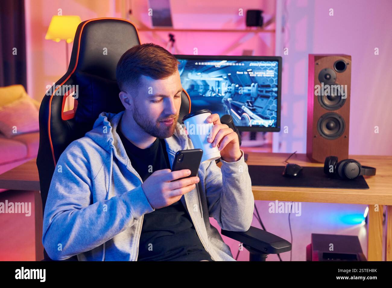 Eine Pause machen. Online-Streamer, der FPS-Shooter zu Hause spielt. Stockfoto