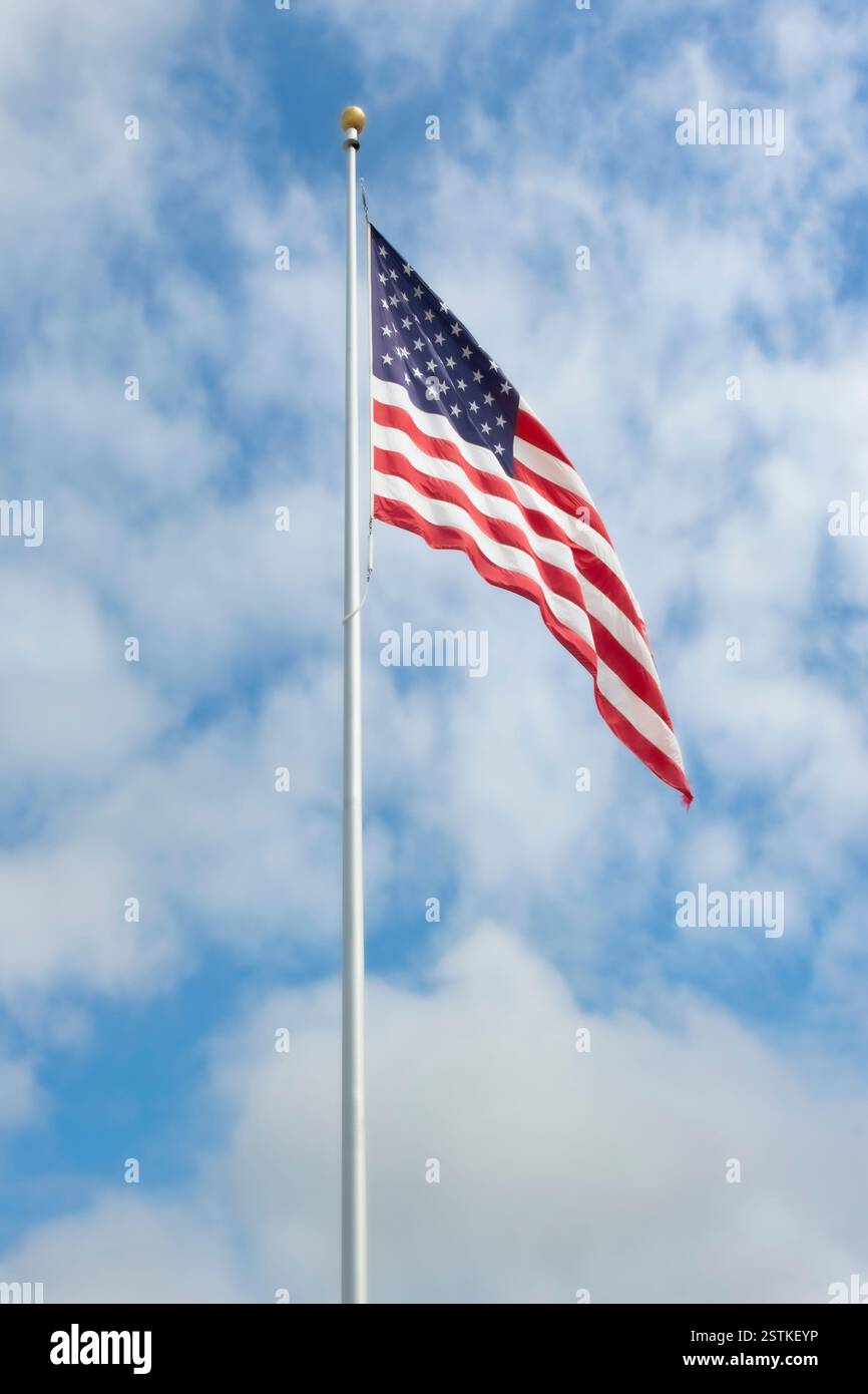 Amerikanische Flagge am Himmel mit geschwollenen weißen Wolken Stockfoto