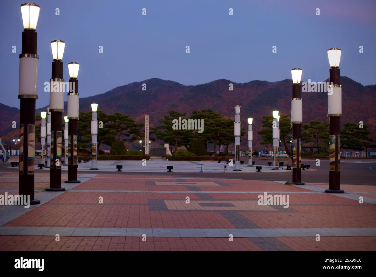 Daejeon, Südkorea - 12. November 2020: Der beleuchtete Innenhof am Daecheong Dam, mit einer symmetrischen Anordnung moderner Laternenpfosten, mit Th Stockfoto