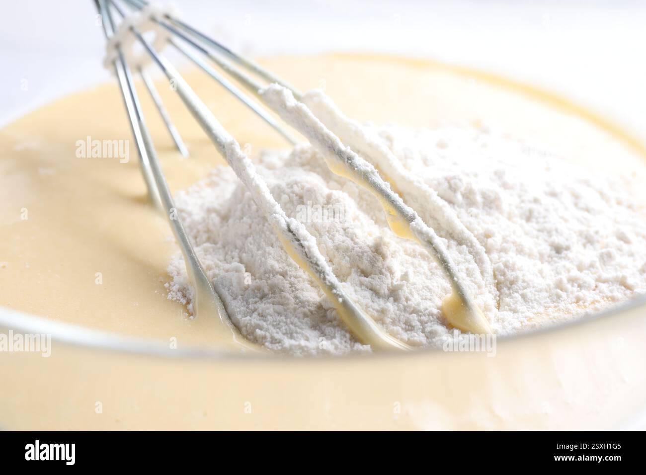 Schneebesen und eine Schüssel Teig, Nahansicht Stockfoto
