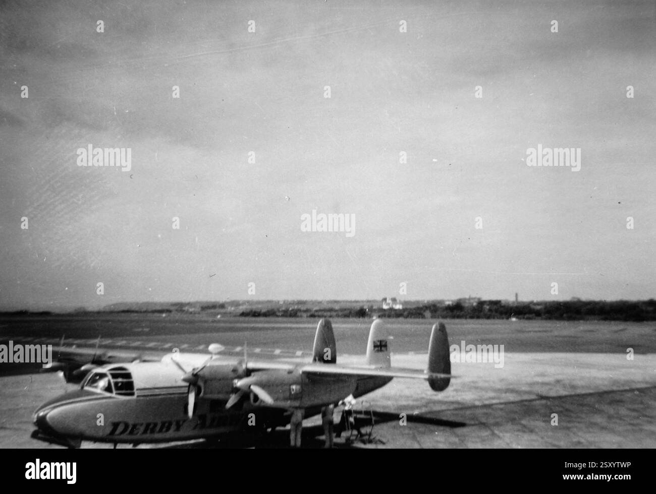 Vintage-Schwarz-weiß-Foto eines Flugzeugs auf der Landebahn, das die klassische Luftfahrtgeschichte und den zeitlosen Stil früherer Flugreisen feststellt. Stockfoto