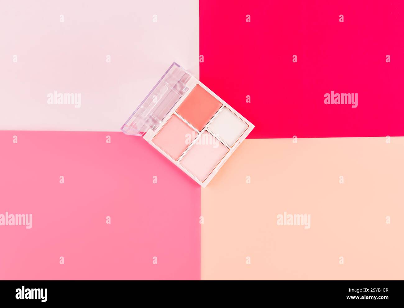 Eine stilvolle Make-up-Palette mit vier Farbtönen liegt auf einem leuchtenden rosa und pfirsichfarbenen Hintergrund. Ideal für Beauty-, Mode- und Kosmetikthemen in Editorial oder Stockfoto