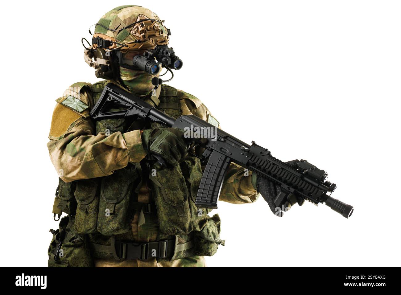 Ein voll ausgestatteter Soldat in Tarnkleidung, der ein Gewehr mit montierten Nachtsichtgeräten hält, vorbereitet für taktische Operationen. Stockfoto