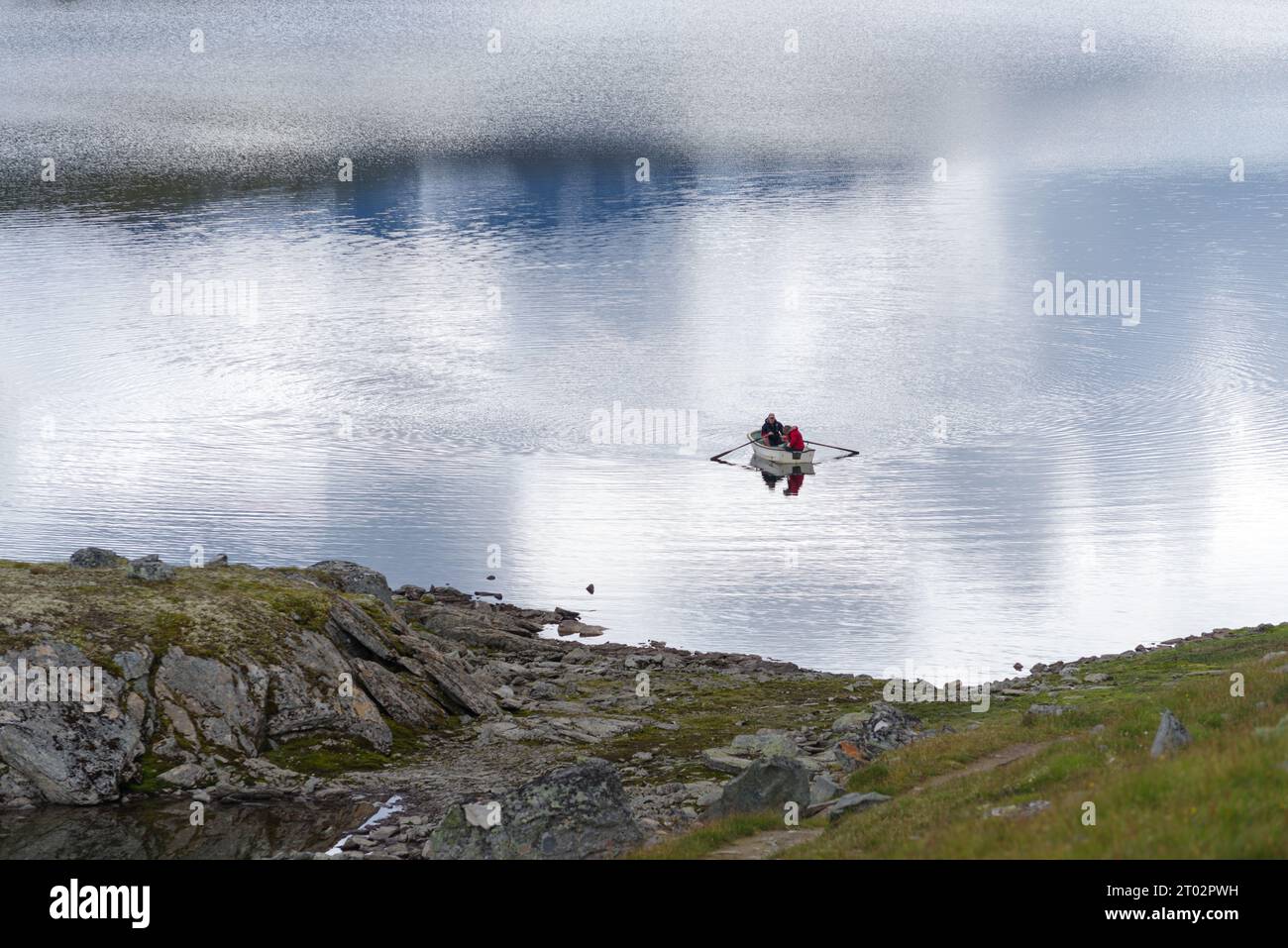 Zwei unbekannte Männer in einem Ruderboot auf einem See in norwegen Stockfoto