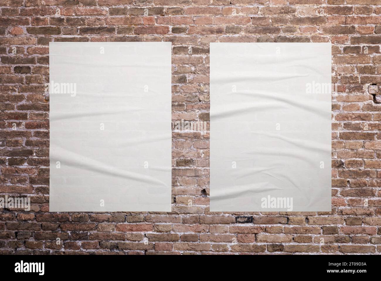 Zwei leere, weiße A3-Poster sind an der Ziegelwand geklebt. Ideale Oberflächen für die Werbeaktion mit Grafikdesign Stockfoto