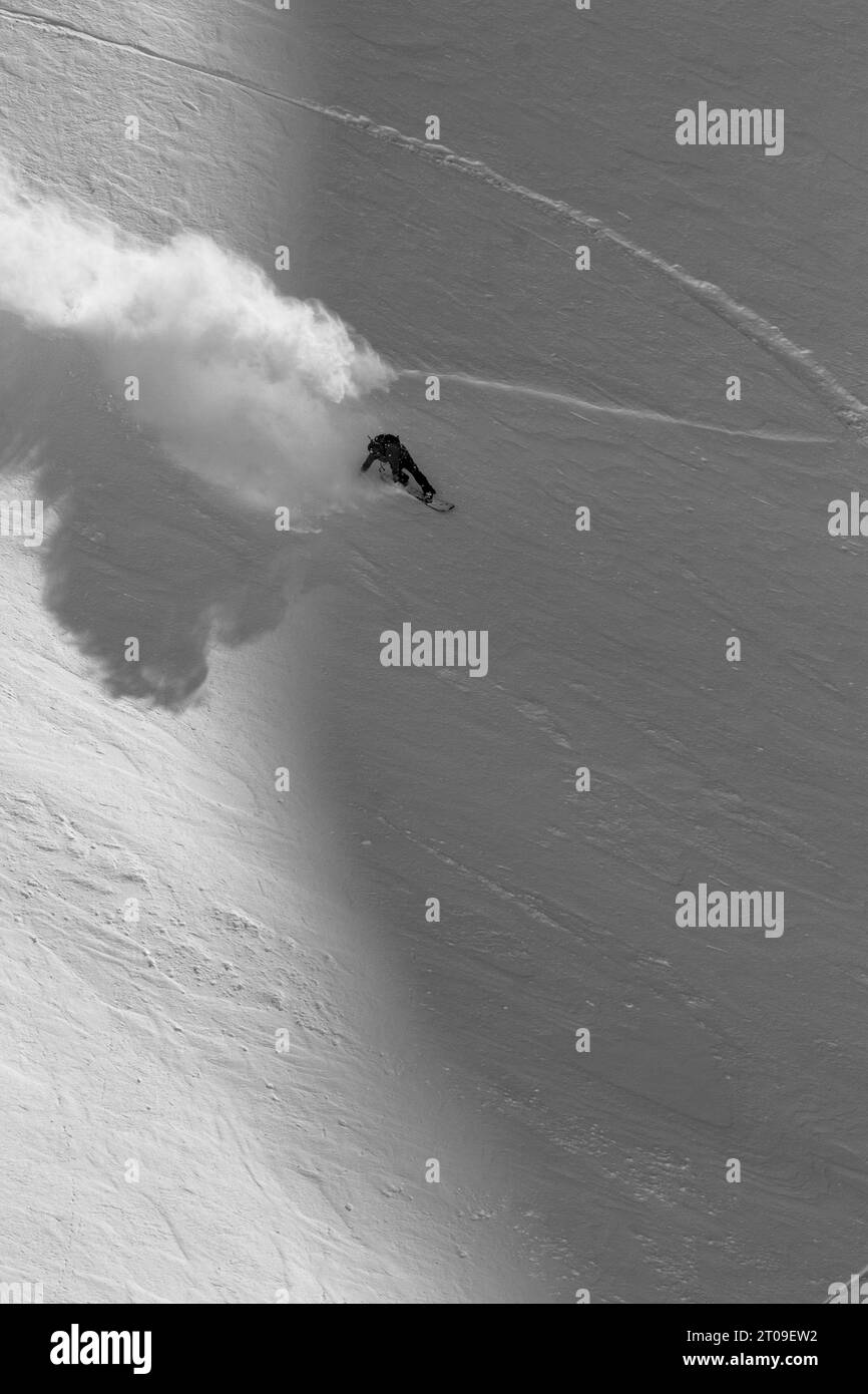 Blick von oben auf anonyme Snowboarder in warmen Skianzügen und mit Snowboards, die in den verschneiten Bergen in Ushuaia Argentinien Sport treiben Stockfoto