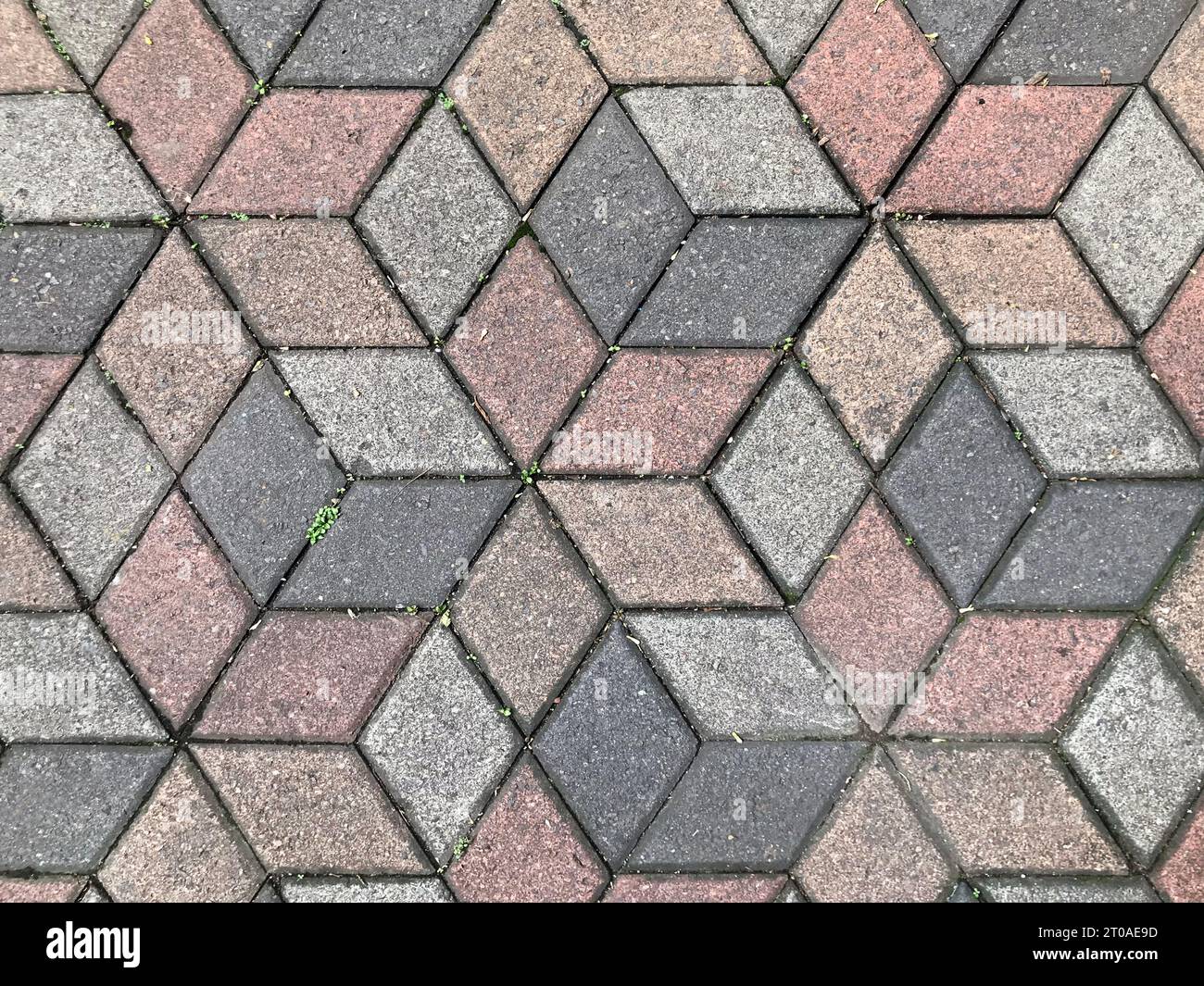 Nahtlose Pflastersteinstruktur im sechseckigen geometrischen Würfelmuster. Dunkelgrau, rosa und grau. Hintergrund der Pflasterstruktur. Querformat Stockfoto