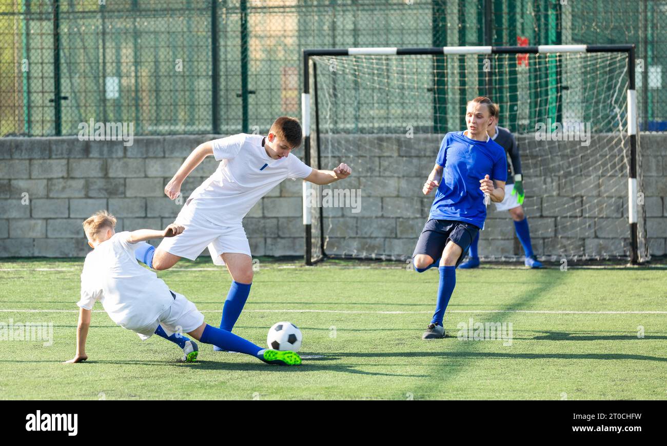 Jugendlicher Fußballspieler mit Angriffsball Stockfoto