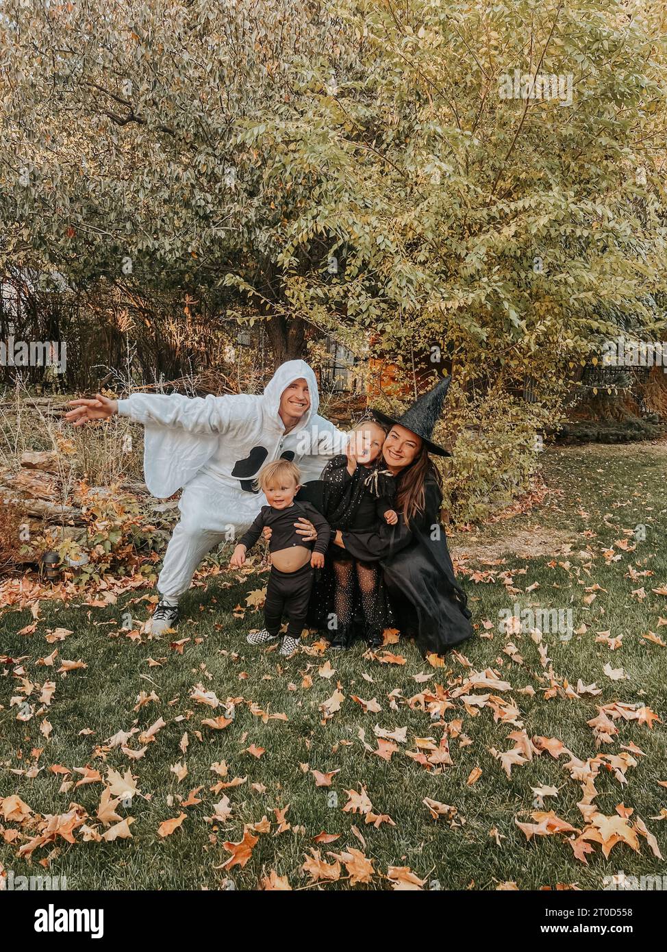 Eine junge Familie posiert spielerisch in ihren Halloween-Kostümen Stockfoto