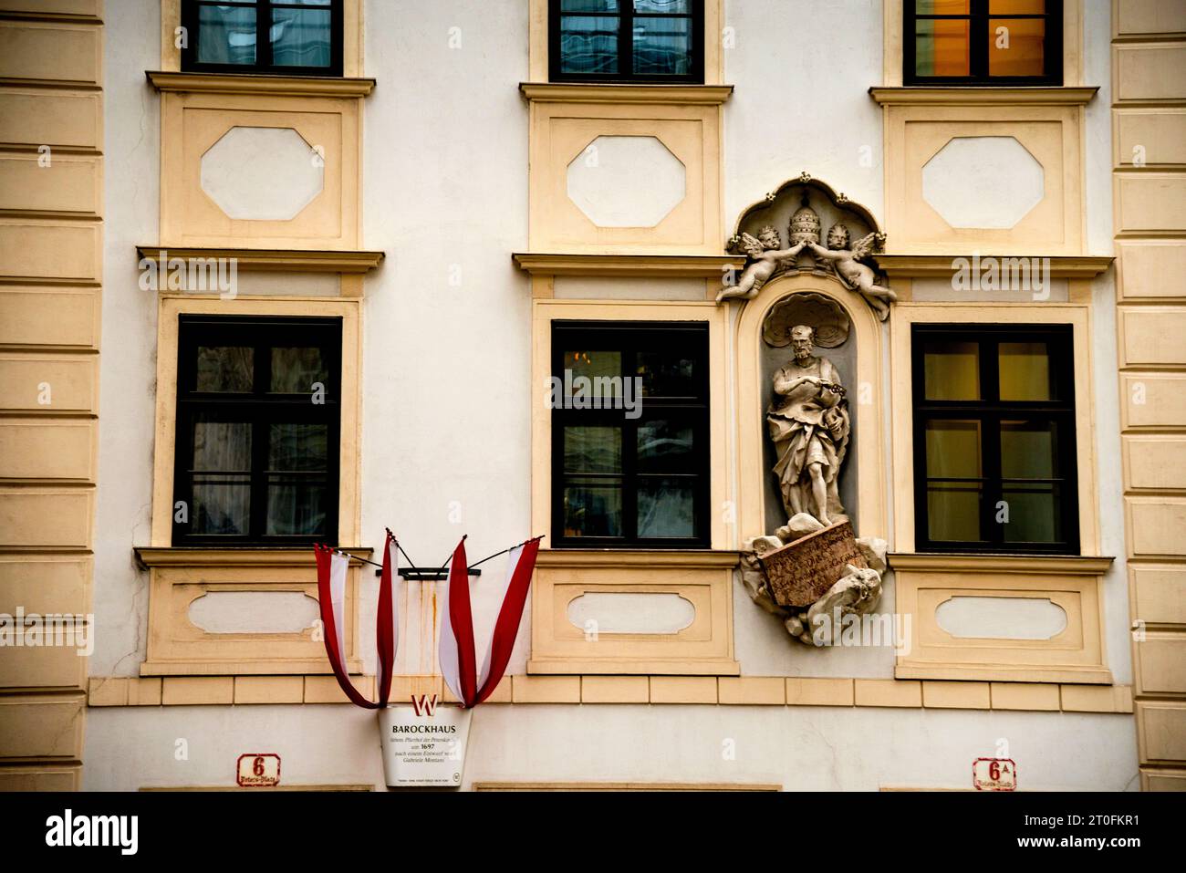 Nische mit der Statue des Heiligen Peter, die einen Schlüssel zum Himmelreich auf dem Petersplatz in Wien hält. Stockfoto