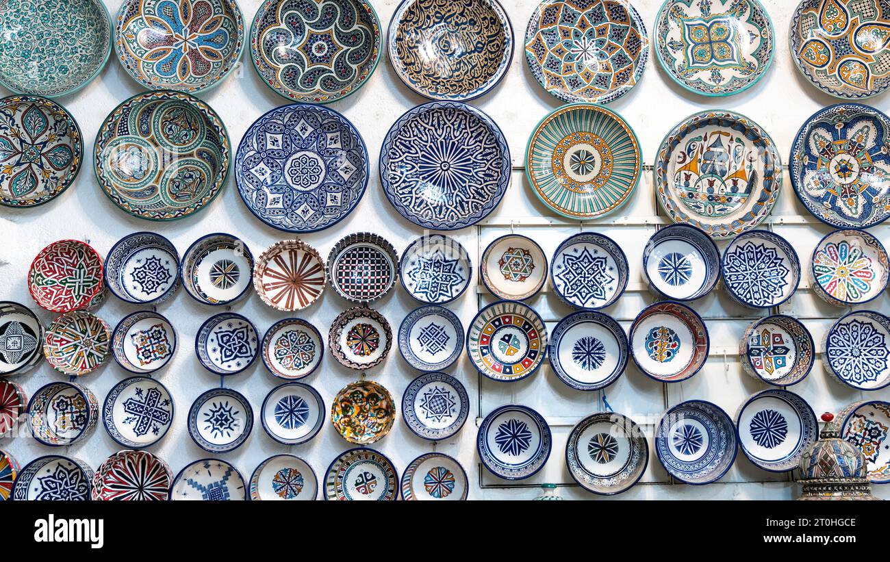 Marokkanische Töpferwaren mit farbenfroher Keramik und Töpferwaren, ausgestellt vor Geschäften in den Souks oder traditionellen Märkten. Stockfoto