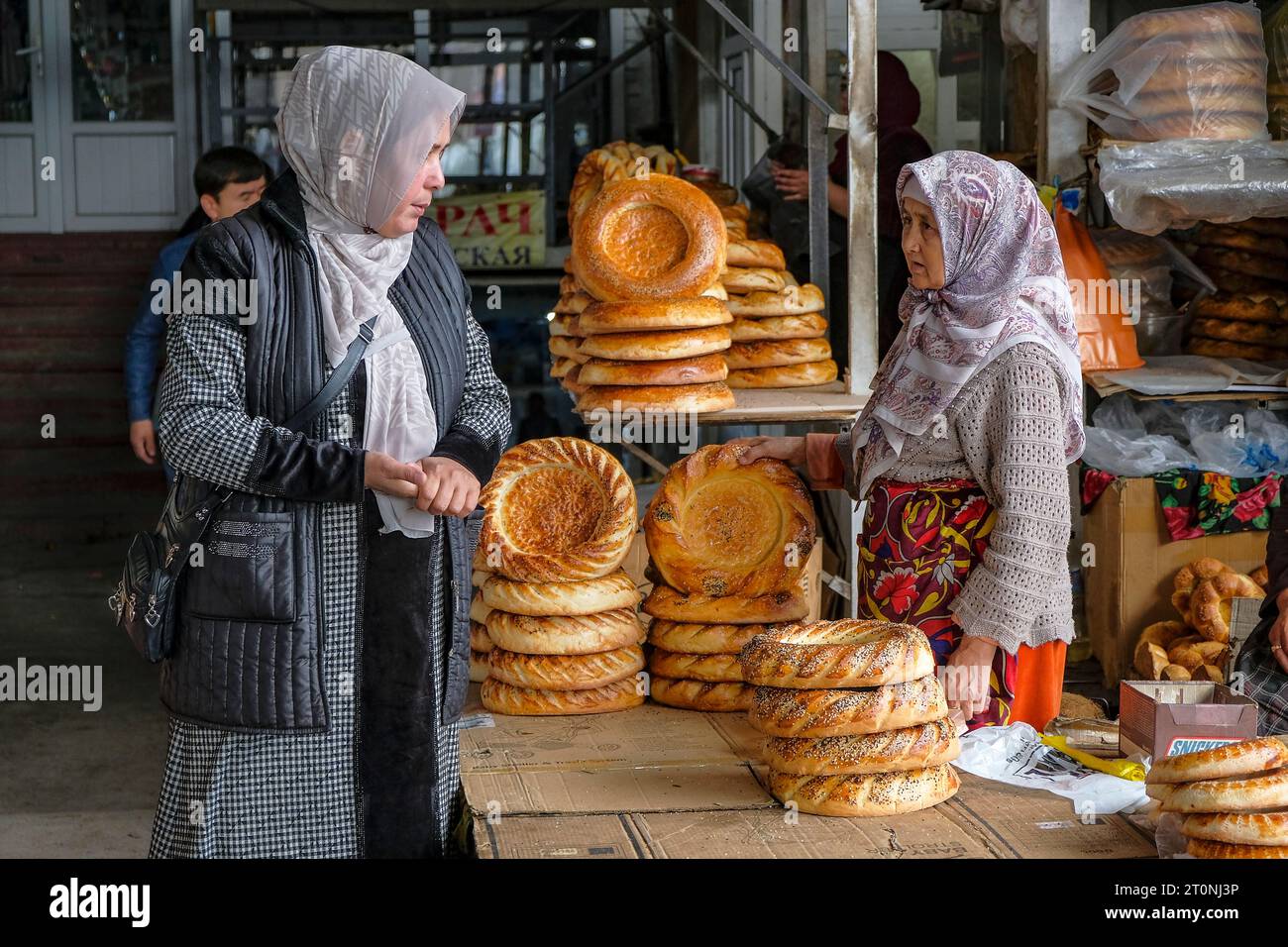 OSH, Kirgisistan - 8. Oktober 2023: Eine Frau, die Brot auf dem Jayma-Basar in Osh, Kirgisistan verkauft. Stockfoto