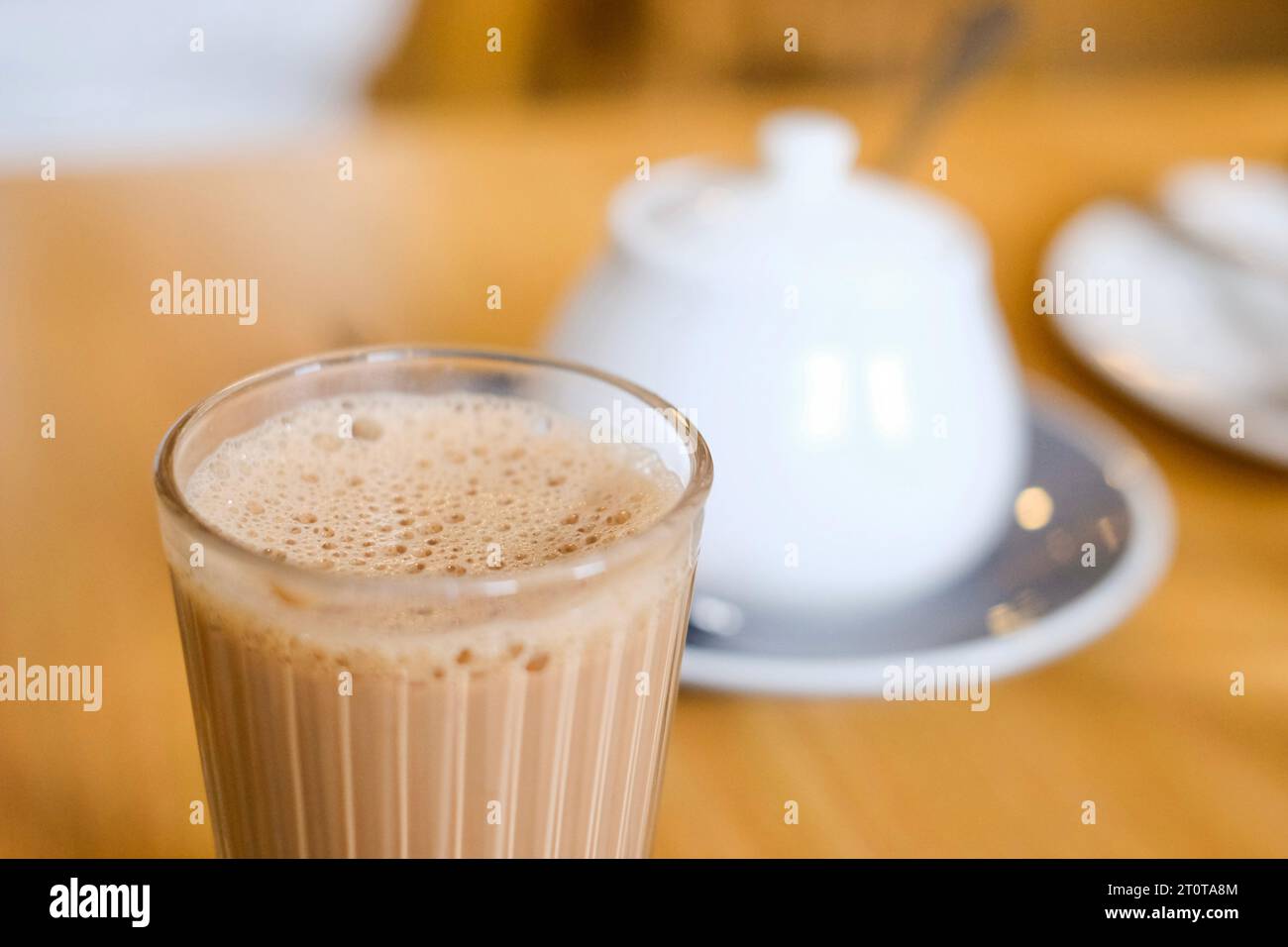 Eine Tasse nepalesischer Gewürzmilchtee (Masala Chai) mit Zuckertopf im Tapari Nights, einem Restaurant in Auburn, Sydney – New South Wales, Australien Stockfoto