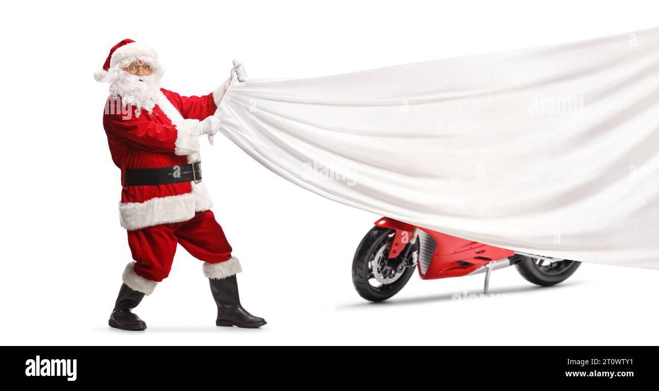 Der Weihnachtsmann zieht ein weißes Stück Tuch vor einem roten Motorrad, isoliert auf weißem Hintergrund Stockfoto