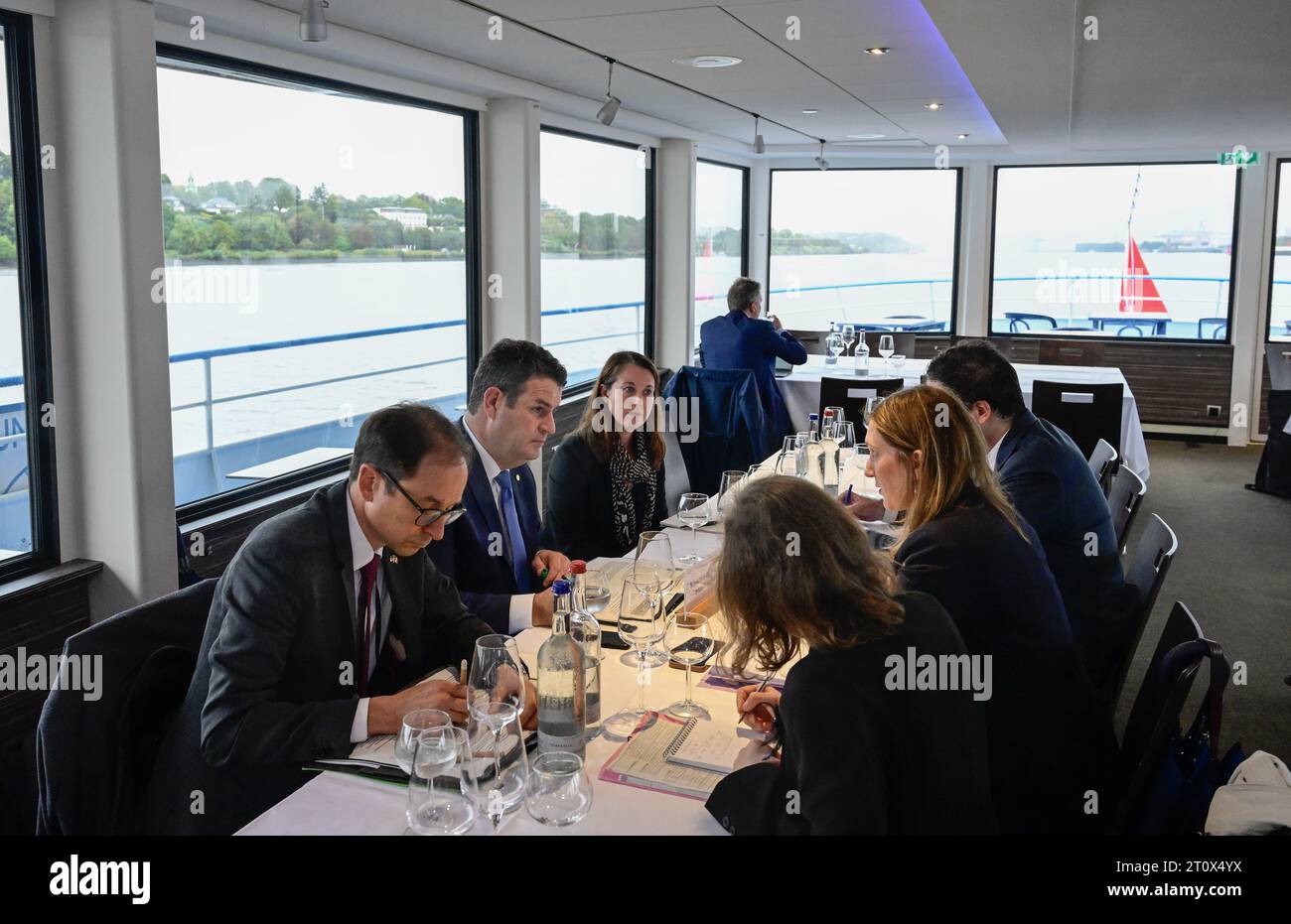 Hamburg, Deutschland. Oktober 2023. Hubertus Heil (2. V. l., SPD), Bundesarbeitsminister, führt während einer Bootsfahrt im Rahmen des deutsch-französischen Retreats ein bilaterales Gespräch. Hinweis: John MacDougall/POOL/dpa/Alamy Live News Stockfoto