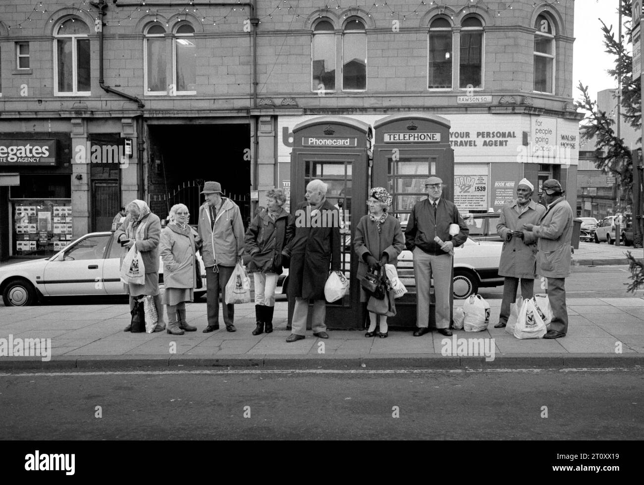 Die vielfältigen multirassischen Menschen in Bradford West Yorkshire warten auf einen Bus am Rawson Square. 1992 Stockfoto