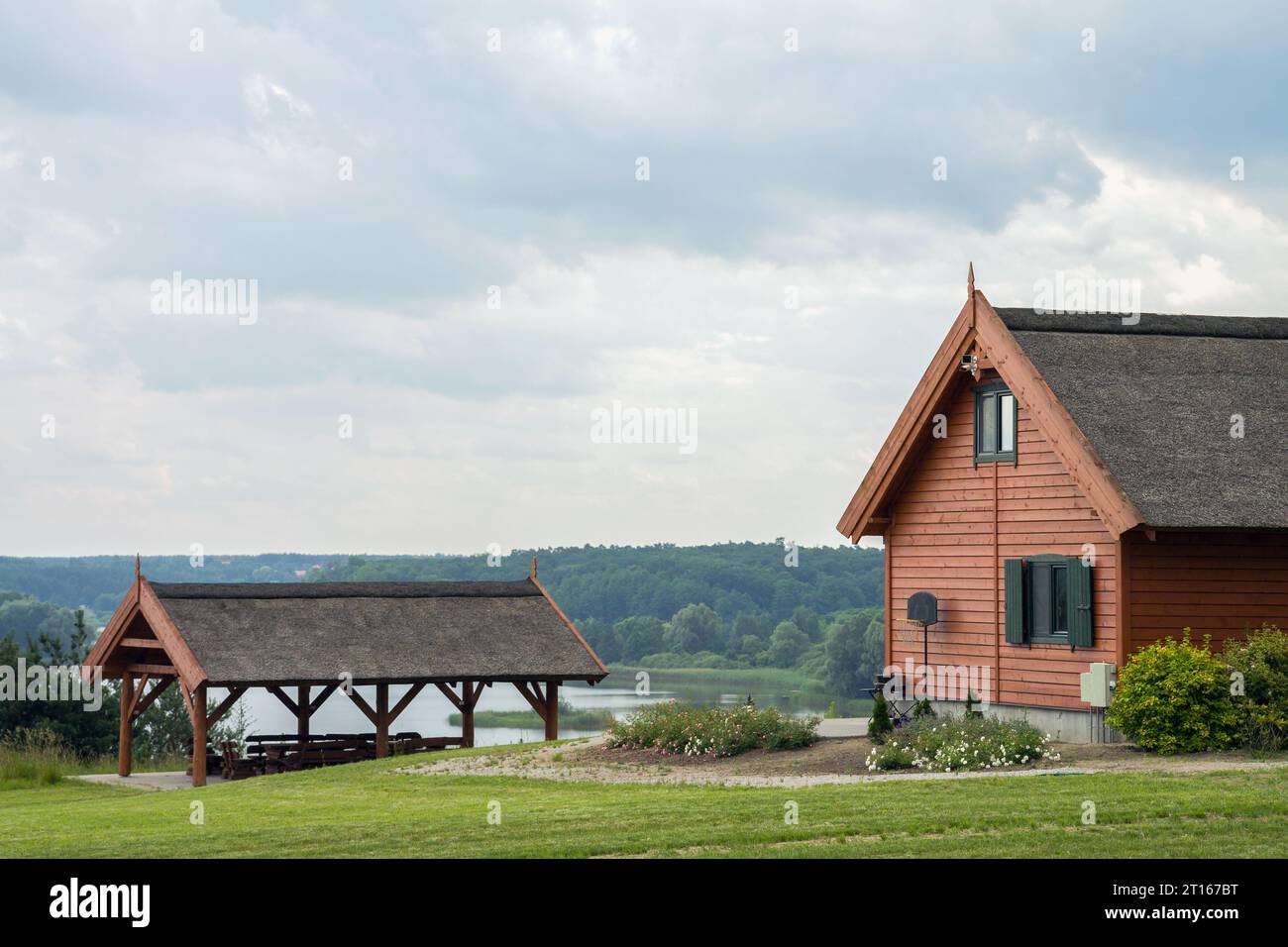 Holzhaus mit Strohdach und Blick auf den See Stockfoto