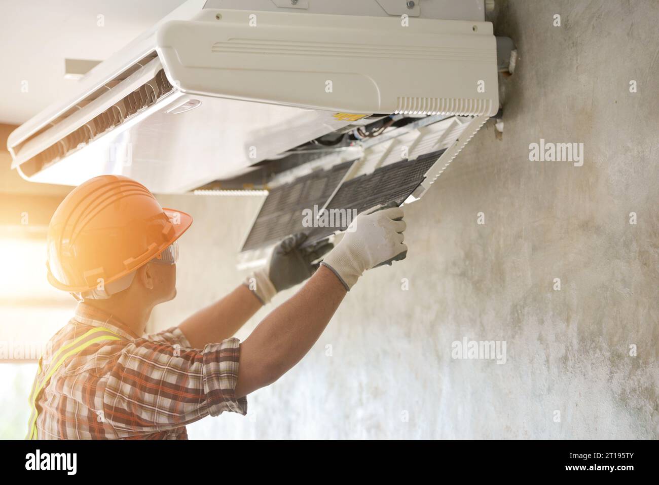 Elektriker Installation einer Klimaanlage an einer Wand, Thailand Stockfoto